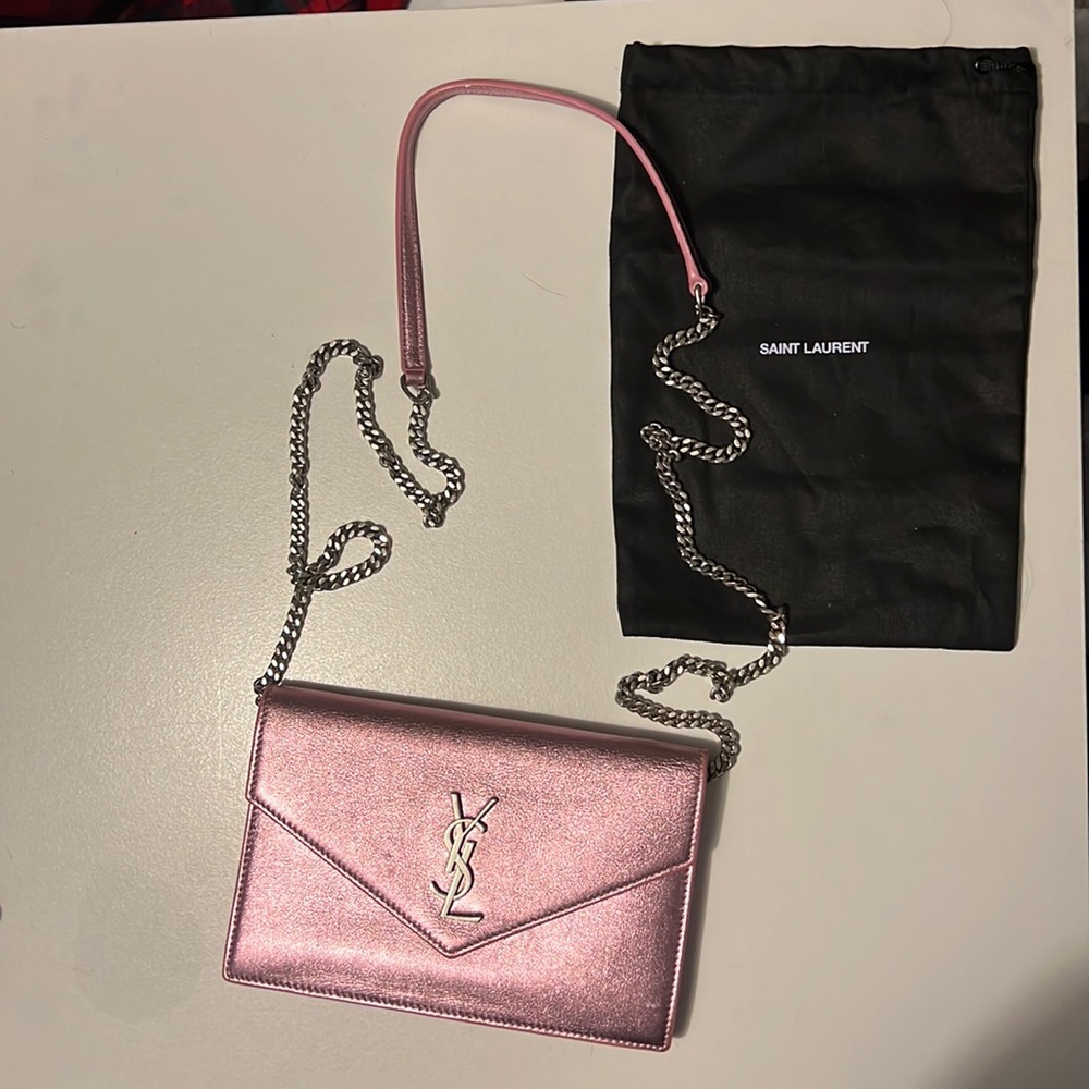 Light iridescent pink YSL wallet on a chain.